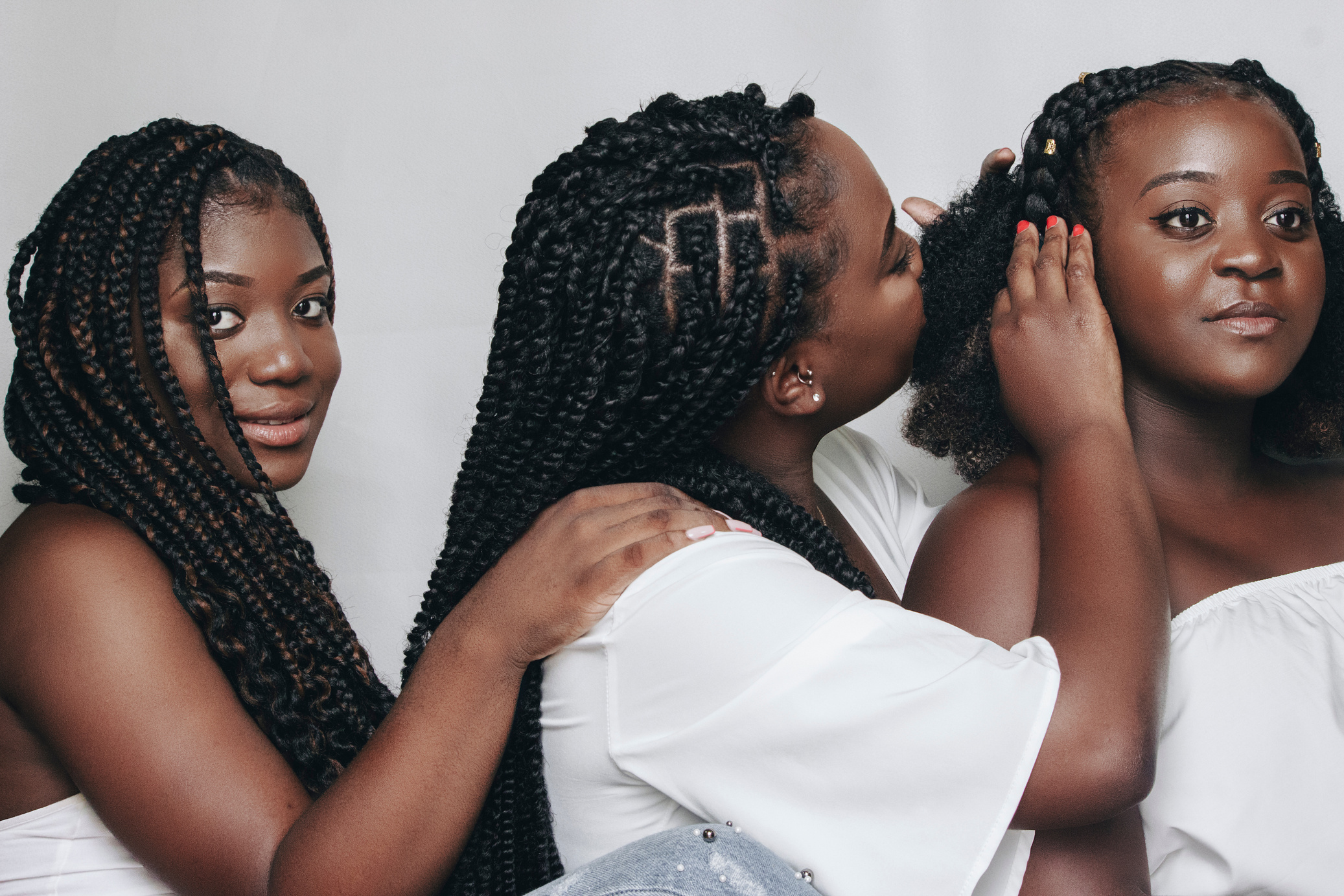 Portrait of Three Smiling Women with Black Hair in Dreadlocks